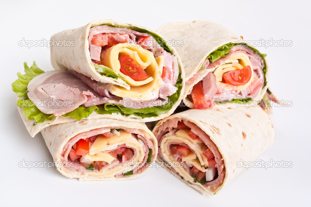 Stack of wrapped tortilla sandwich rolls cut in half