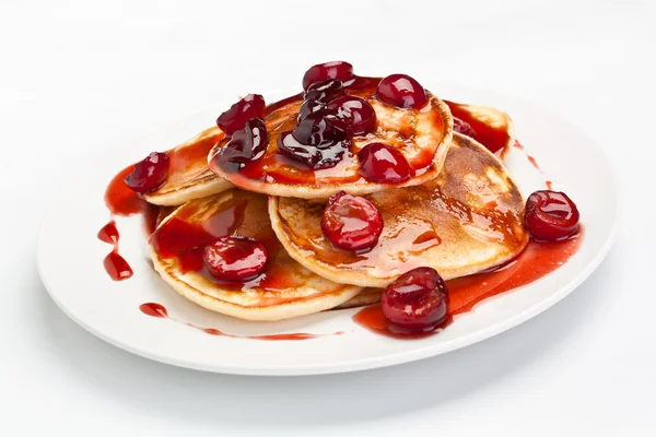 Pancakes with sweet cherry sauce — Stock Photo, Image