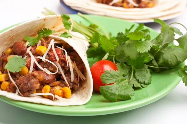 Burrito y cilantro en un plato — Foto de Stock