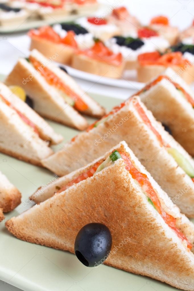 club sandwiches with salmon and cucumbers