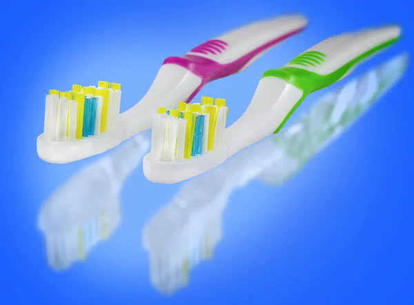 Tooth brushes on blue background. — Stock Photo, Image