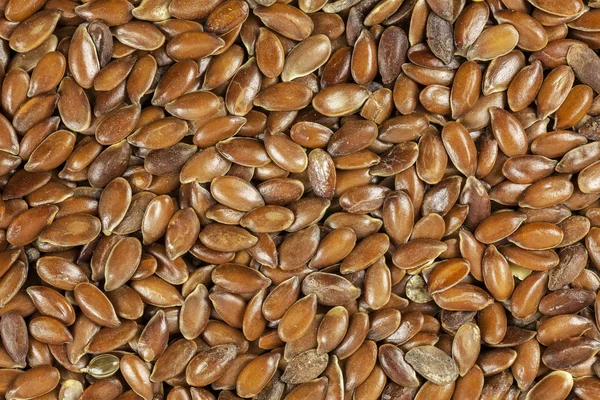 Brown flax seeds background, close up. — Stock Photo, Image