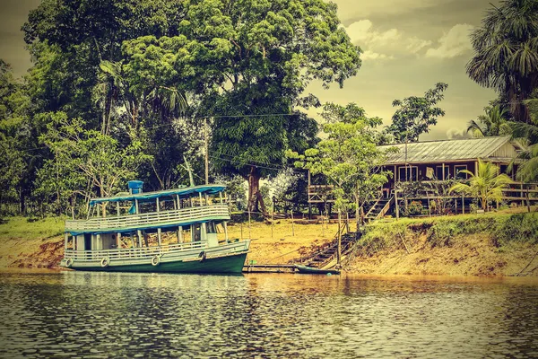 Wooden boat on the Amazon river, Brazil, vintage retro instagram — Stock Photo, Image
