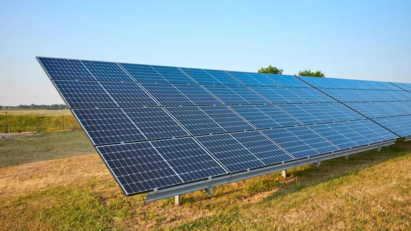 Picture of solar panel modules on a field, selective focus.