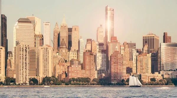 Manhattan waterfront at sunset, retro color toning applied, New York City, USA.