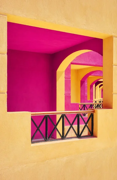 Pink and yellow painted building facade, selective focus, architecture background.
