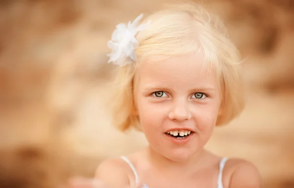 Cute little girl with a flower in her hair — Stock Photo, Image