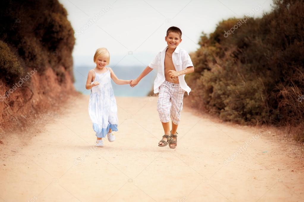 Boy and girl run on road