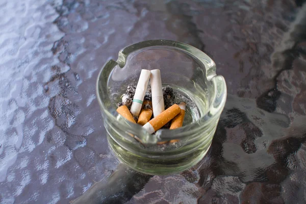 Overhead of burning cigarette in ashtray — Stock Photo, Image