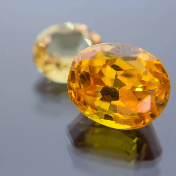 Natural Sapphire gemstone, Jewel or gems on black shine color, natural yellow gemstones on stone