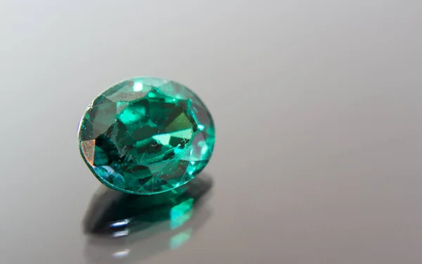 Natural Green Sapphire gemstone. Beautiful green gemstone gemstone isolated on a black background, as jewelry background