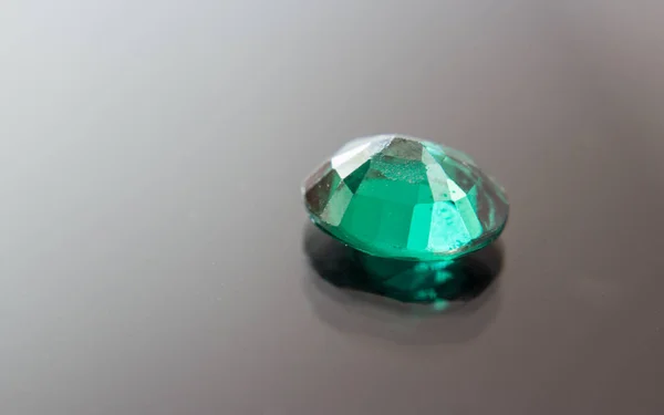 Natural Green Sapphire gemstone. Beautiful green gemstone gemstone isolated on a black background, as jewelry background