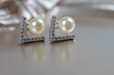 Güzel bir Pearl Ear çivisi. Beyaz inci küpelerin yakın çekimi.