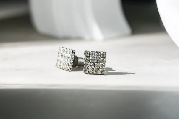 beautiful diamond earrings. Close-up of white diamond earrings.