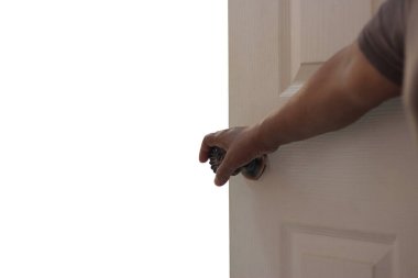 Kadın elini beyaz arka plandan soyutlayarak kapıyı açıyor..