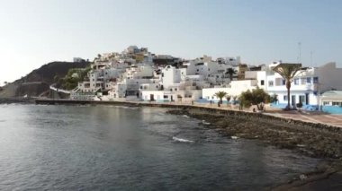 Sahilin ve Kanarya Adaları 'ndaki Fuerteventura adasının doğu kıyısındaki Las Playitas sahil kasabasının havadan görüntüsü. İspanya, 4k video
