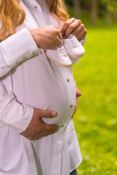 Duas Pessoas Irreconhecíveis Com Duas Botas Bebê Uma Barriga Uma — Fotografia de Stock