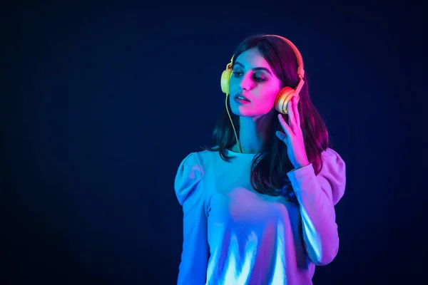 Young Caucasian Brunette Yellow Headphones Black Background Illuminated Disco Neon — 图库照片