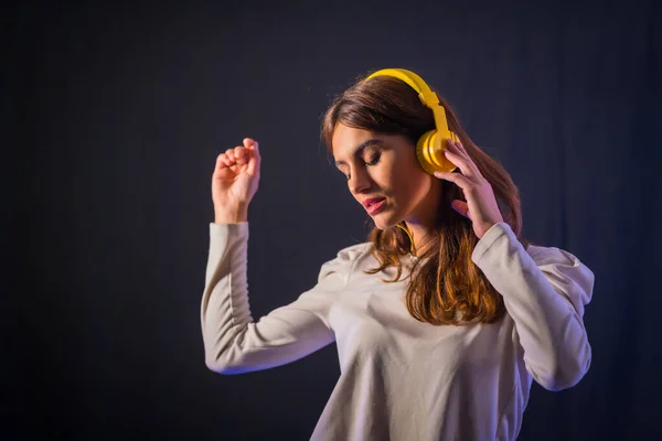 Young Caucasian Brunette Yellow Headphones Black Background Smiling Dancing Nightclub — Fotografia de Stock