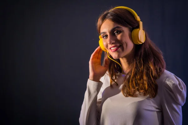 Young Caucasian Brunette Yellow Headphones Black Background Smiling Looking Nightclub — Fotografia de Stock