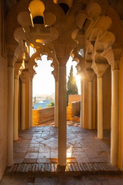 Watching the sunset from the Arab doors of a courtyard of the Alcazaba in the city of Malaga, Andalusia. Spain. Medieval fortress in arabic style