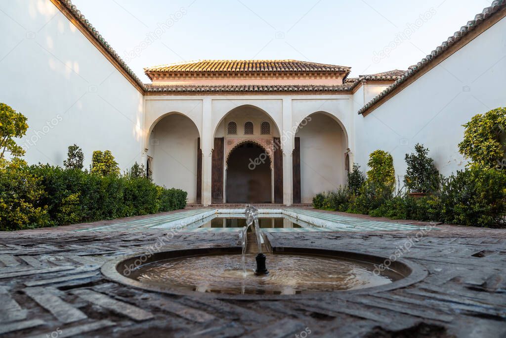Beautiful courtyard with water fountains inside the Alcazaba in the city of Malaga, Andalusia. Spain. Medieval fortress in arabic style