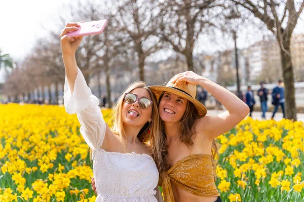 Amici Vacanza Città Con Cappelli Paglia Accanto Alcuni Bellissimi Fiori — Foto Stock
