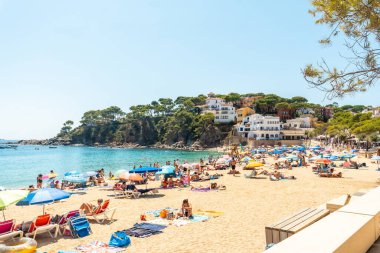 Girona yazında Katalonya 'nın Costa Brava' sında insanlarla dolu Llafranc plajı