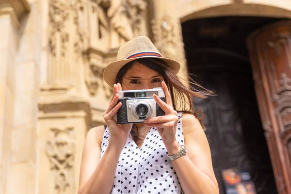 戴帽子参观教堂 用相机拍照 享受春假或暑假的女性游客 女性游客的概念和数字内容创建者 — 图库照片
