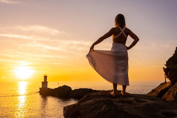 Uma Mulher Loira Vestido Branco Pôr Sol Lado Farol Mar — Fotografia de Stock