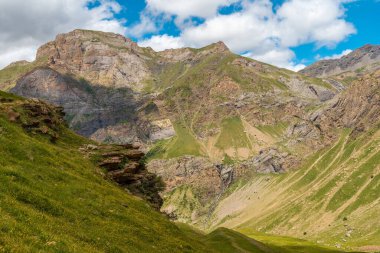 View of the corner of the green and the Salto de Tendenera waterfall in the Ripera valley, Pyrenees