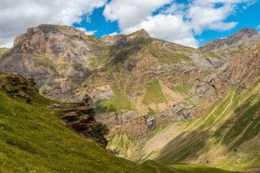 A young man looking at the landscape in the rincon del verde and the Salto de Tendenera Waterfall in the Ripera Valley, Pyrenees