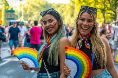 Madrid, Spain: July 9, 2022: A couple of bisexual girls enjoying themselves at the gay pride party, lgbt in Madrid