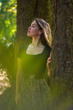 Young woman next to a tree in nature in a natural park