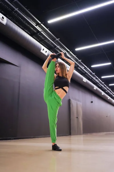 Woman urban hip-hop dancer inside a black building building