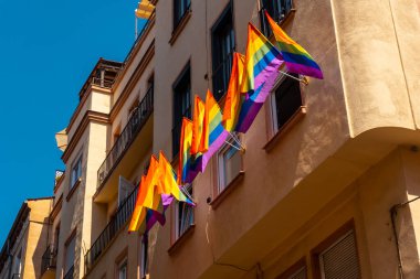 lgbt flags hanging in the streets and balconies at the pride party in madrid