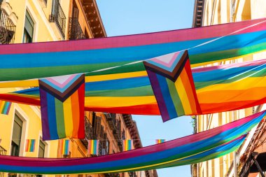 LGBT flags in the streets and balconies at the pride party in Madrid clipart