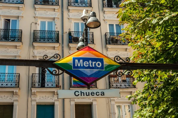 Sign of the metro station in the Chueca neighborhood of Madrid adronado with colors of the lgtb rainbow flag