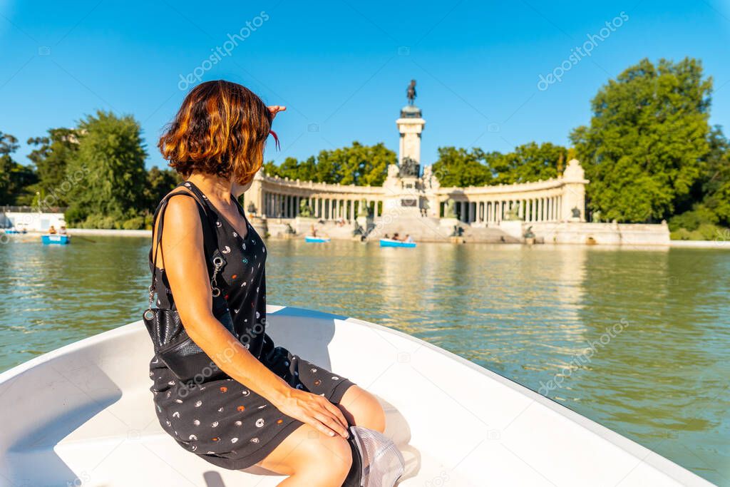 A tourist in the boat of the Estanque Grande de El Retiro in the city of Madrid. Spain
