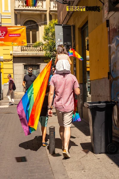 Families with the lgbt flags in the streets at the pride party in Madrid