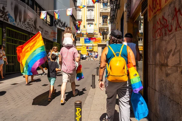 Families with the lgbt flags in the streets at the pride party in Madrid