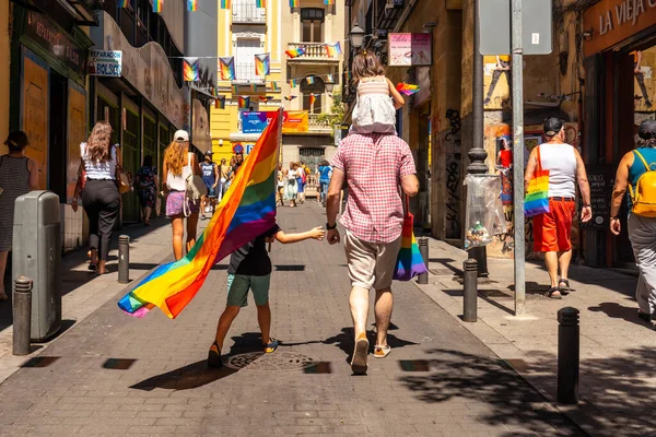 Families with the lgbt flags in the streets at the pride party in Madrid