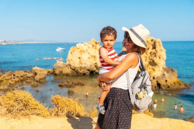 Mother with her son at Praia dos Arrifes, Algarve beach, Albufeira. Portugal. tourism in summer