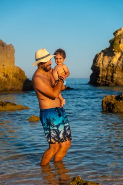 A father with his baby on vacation at Praia dos Arrifes, Algarve beach, Albufeira. Portugal