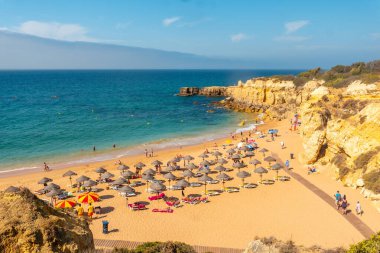 Beautiful beach with umbrellas on vacation at Praia da Mare das Porcas, Algarve, Albufeira. Portugal