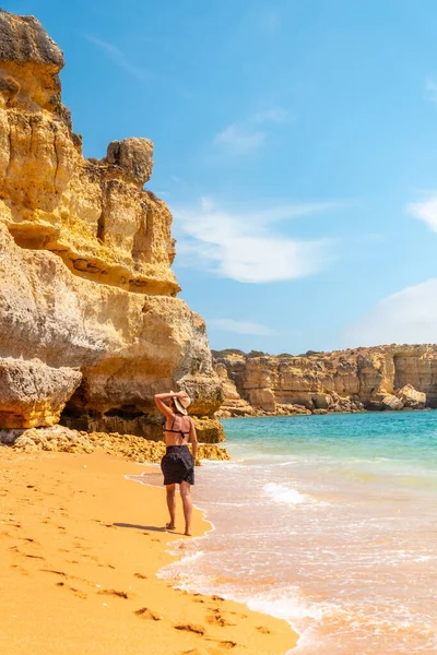 Strolling in summer on vacation on the beach at Praia da Coelha, Algarve, Albufeira. Portugal