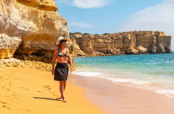 Strolling in summer on vacation on the beach at Praia da Coelha, Algarve, Albufeira. Portugal