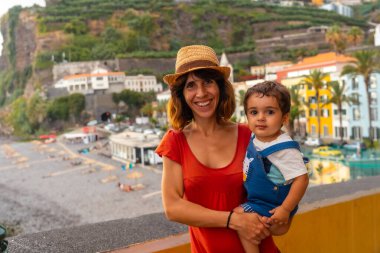 A mother and son on summer vacation at Ponta do Sol Beach, Madeira. Portugal