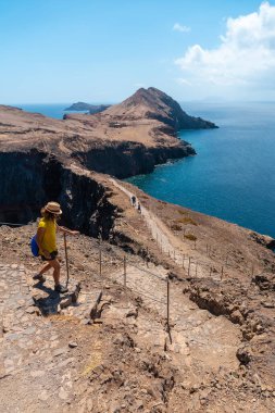 A young woman in Sao Lourenco going down the stairs of the trekking trail, Madeira