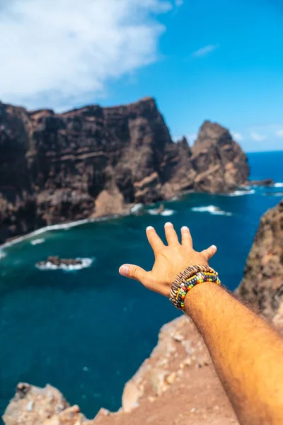 Hand of a young man with bracelets in Ponta de Sao Lourenco in summer, Madeira